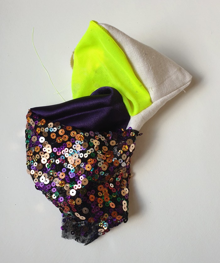 Amorphous fabric construction made from neon fabric and other textiles.